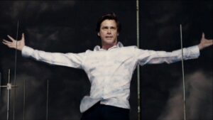 Jim Carrey in a white shirt holding his arms wide in a scene from Bruce Almighty
