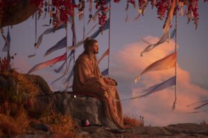 Thor sits peacefully atop a mountain in a robe in Thor: Love and Thunder