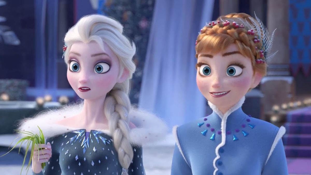 Princesses Anna and Elsa, both in blue formalwear and hair braids, stare at something offscreen in Olaf’s Frozen Adventure
