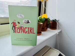 Fangirl novel next to some plants in a windowsill