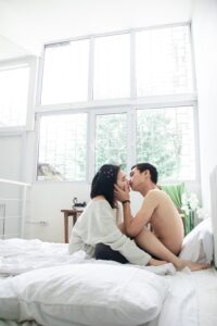couple in bed kissing after learning how to manifest someone and love using the law of attraction