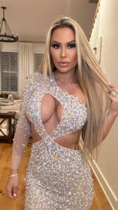 Kindly Myers in a cut-out silver dress