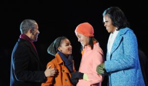 WASHINGTON, DC - DECEMBER 6: (AFP OUT) U.S. President Barack Obama (L) with his wife first lady Michelle Obama (R) and their daughters Malia (2nd R) and Sasha Obama light the 90th National Christmas Tree during the Lighting Ceremony on the Ellipse behind the White House on December 6, 2012 in Washington, DC. This year is the 90th annual National Christmas Tree Lighting Ceremony. (Photo by Olivier Douliery-Pool/Getty Images)