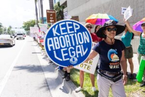 FORT LAUDERDALE, FLORIDA - JULY 13: An abortion rights activist holds a sign at a protest in support of abortion access, March To Roe The Vote And Send A Message To Florida Politicians That Abortion Access Must Be Protected And Defended, on July 13, 2022 in Fort Lauderdale, Florida. (Photo by John Parra/Getty Images for MoveOn)