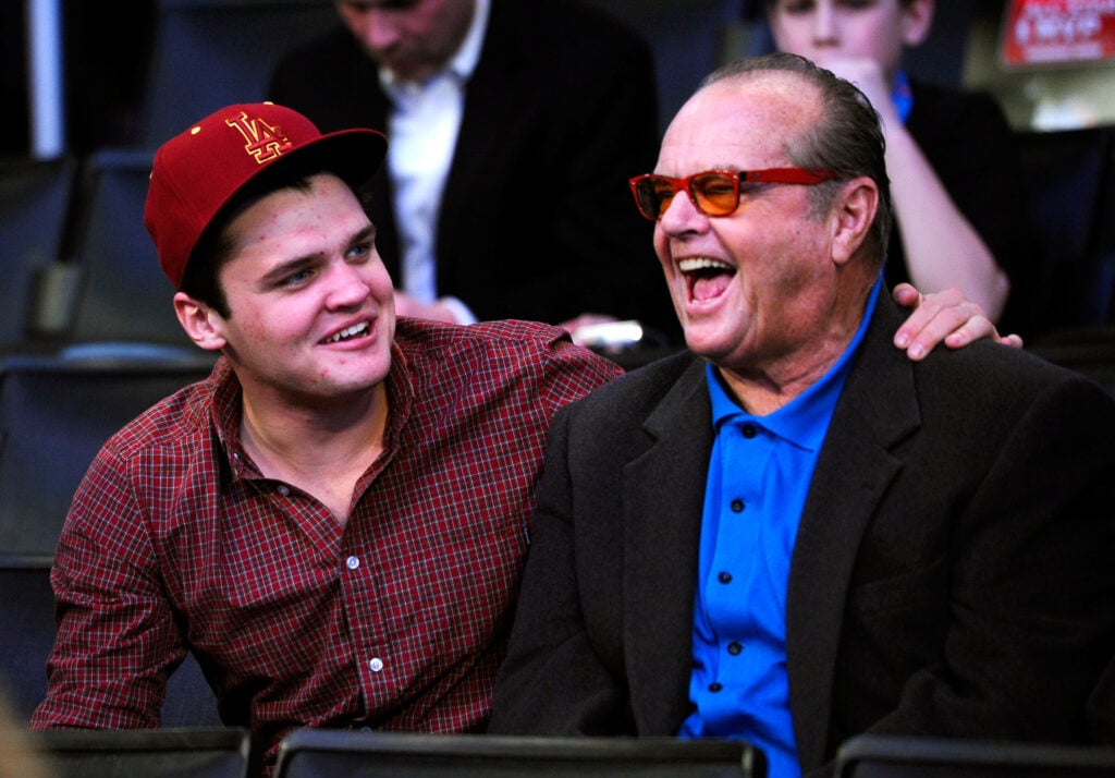 Actor Jack Nicholson (R) and his son Raymond Nicholson speak during the 2011 NBA All-Star game