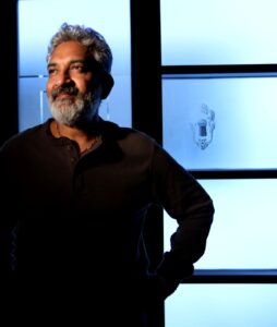 Filmmaker S.S. Rajamouli stands with hand on hip for a portrait.