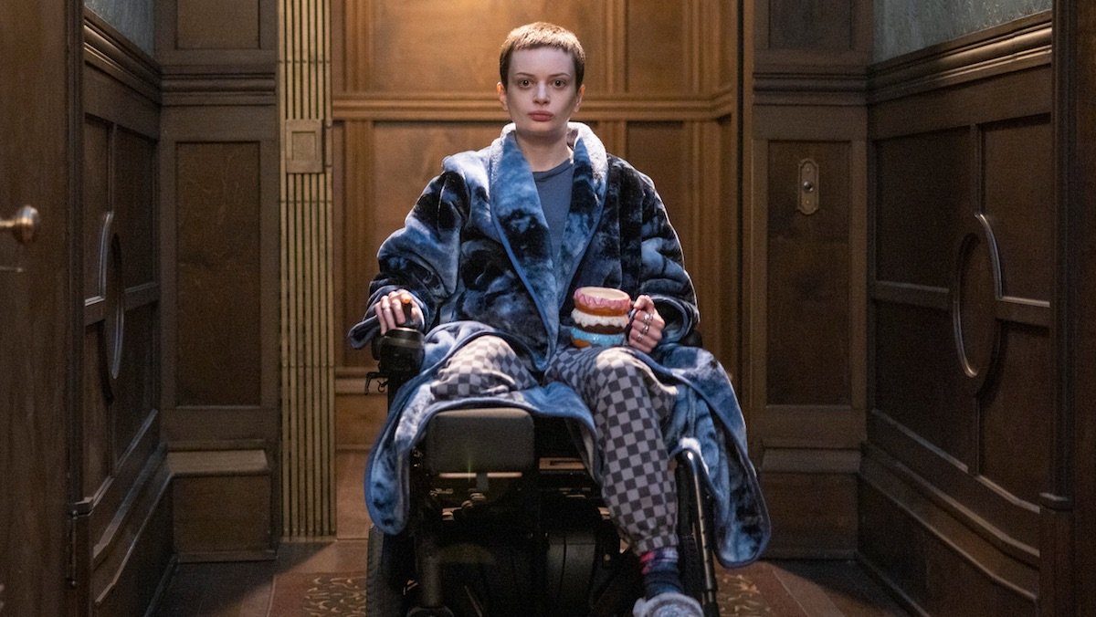 Ruth Cobb as Anya on The Midnight Club sits alone in her wheelchair outside the elevator