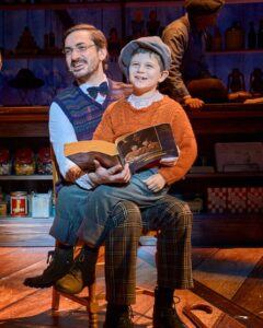 Wholesome … George Maguire as Cratchit and Samuel Sturge as Tiny Tim in Dolly Parton’s Smoky Mountain Christmas Carol.