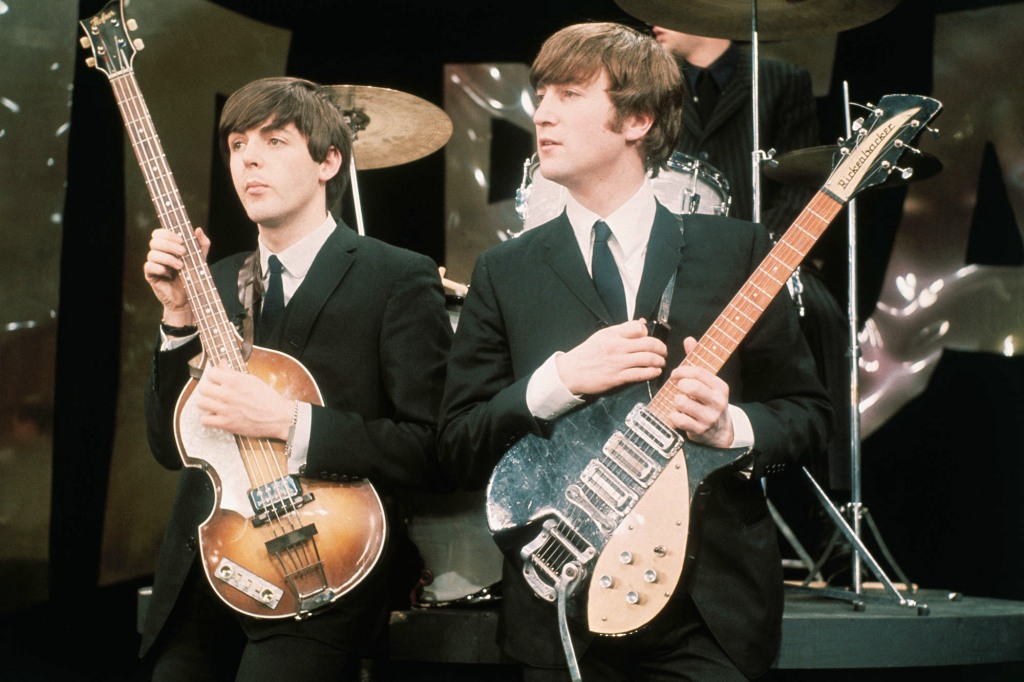Paul McCartney and John Lennon hold their guitars while on the set of The Ed Sullivan Show at the CBS television studios in Manhattan, where the Fab Four are performing their nationwide television debut.