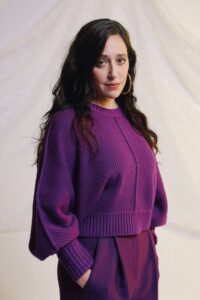 Actor Mariana Treviño in a purple ensemble.