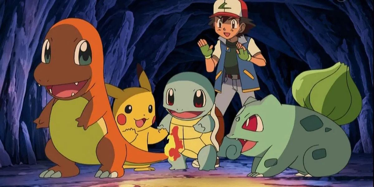 A black-haired anime boy (Ash), along with three smiling creatures (L-R Pikachu, Squirtle, Bulbasaur), huddle around the flaming tail of an orange creature (Charmander) in a dark cave.