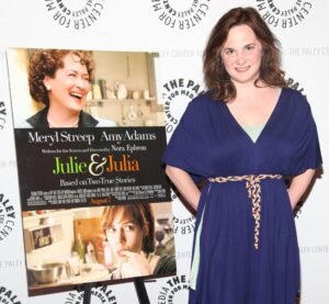 Julie Powell attends a screening of "Julie and Julia" while wearing a navy blue dress