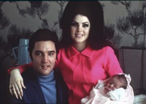 Elvis Presley poses with wife Priscilla and daughter Lisa Marie, in a room at Baptist hospital in Memphis, Tenn., 1968.