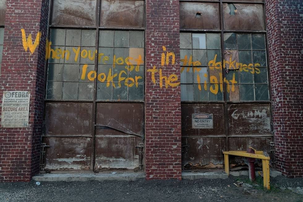 Graffiti of the Fireflies slogan, When you're lost in darkness, look for the light from The Last of Us.