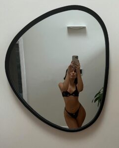 Emily Faye Miller snaps a mirror selfie in black lingerie
