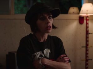 Fairuza Balk in a black hat and a black t-shirt with her arms crossed from a scene in 'Paradise City.'