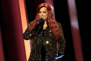 NASHVILLE, TENNESSEE - NOVEMBER 09: Wynonna Judd speaks onstage at The 56th Annual CMA Awards at Bridgestone Arena on November 09, 2022 in Nashville, Tennessee.