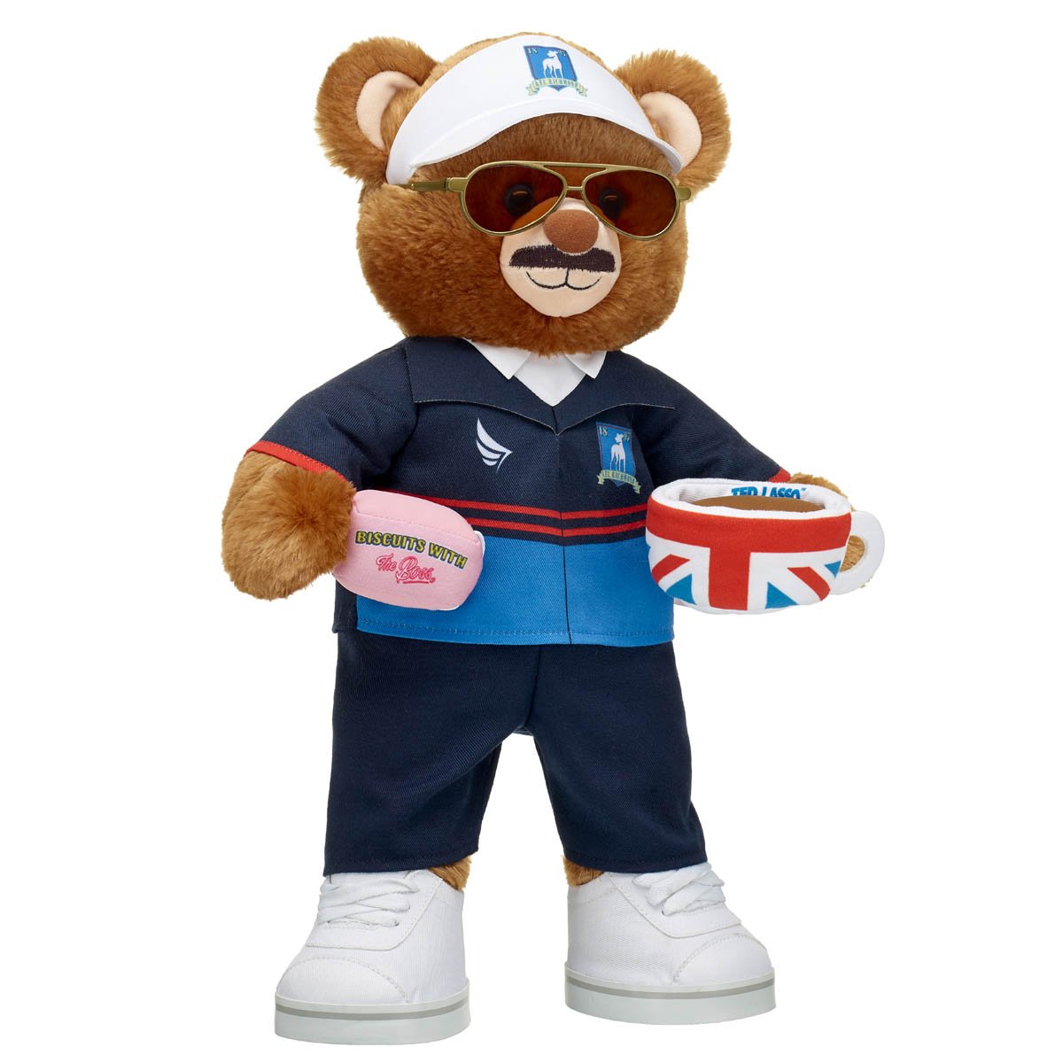 Build-A-Bear's Ted Lasso Plush doll with Biscuits with the boss box and Union Jack tea cup standing
