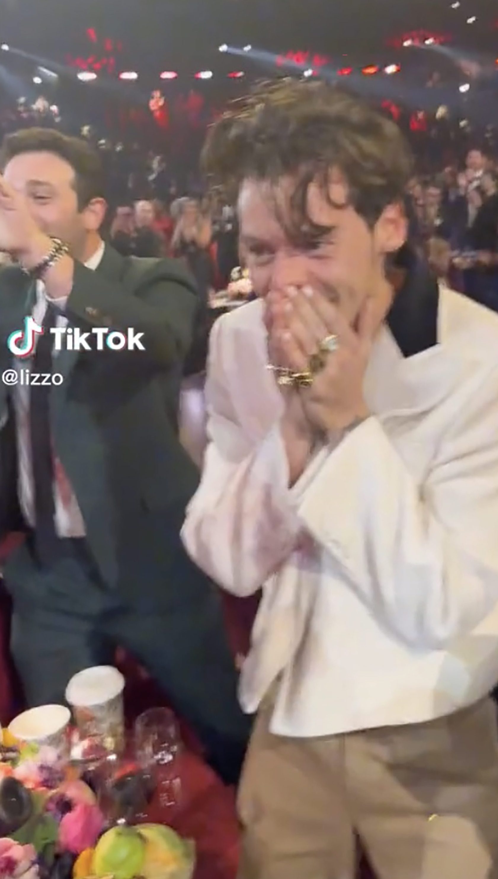 A supportive Lizzo filmed Styles looking delighted after he won Album of the Year. 