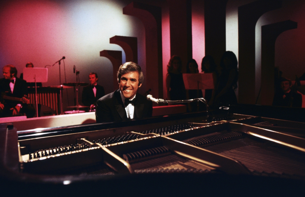 Burt Bacharach performs with his piano circa 1968 in Los Angeles, California.