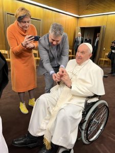 Director Evgeny Afineevsky helps Pope Francis put on a bracelet presented as a gift by Ukrainian women from the documentary 'Freedom on Fire.' Next to Afineevsky is journalist Nataliia Nagorna.