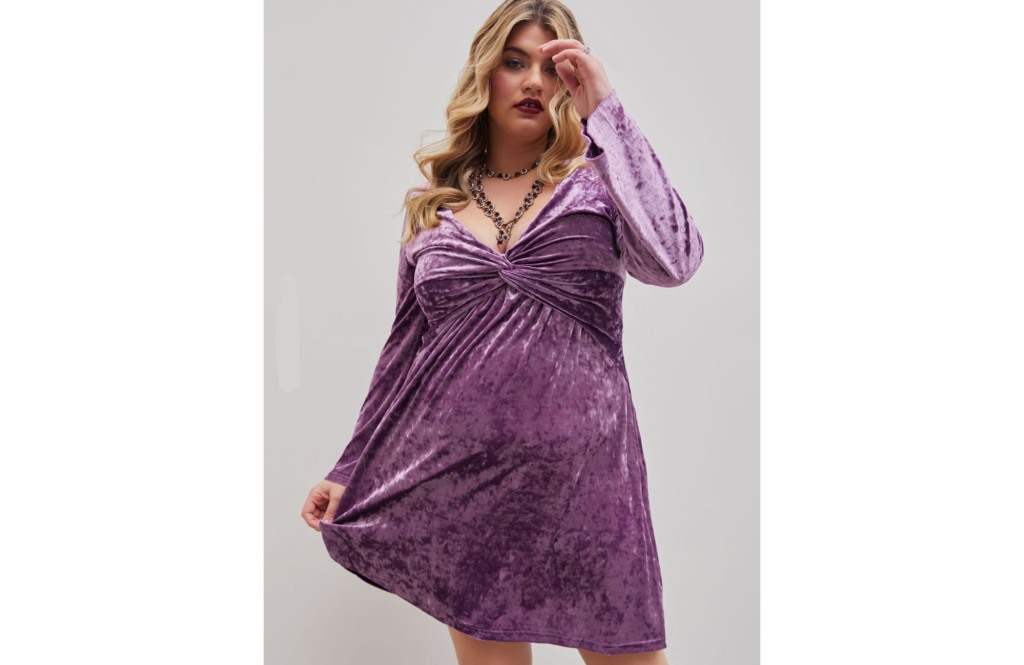 Blonde woman in a velvet purple flowy dress