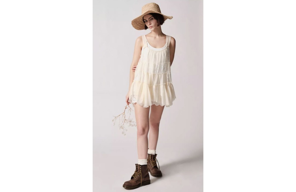 girl in a sunhat, beige lace dress, and brown boots