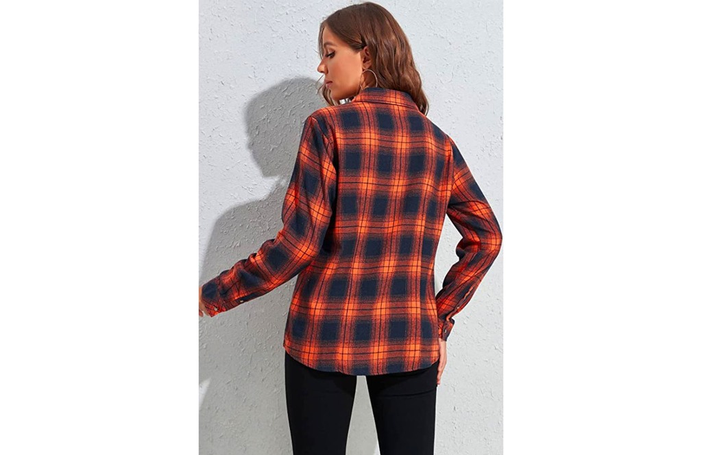 woman's back wearing an orange and navy flannel