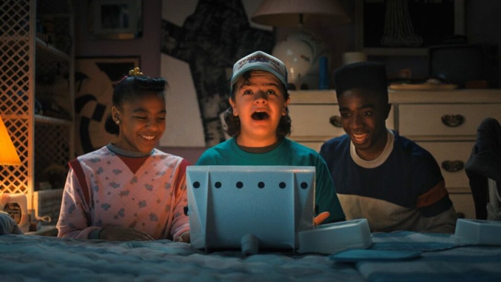 Stranger Things Dustin, Erica, Lucas are excited, for Netflix price cost decrease article.