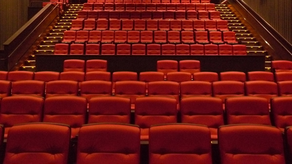 An empty movie theater full of red seats. AMC is about to make your ticket cost more depending on your seat choice. 