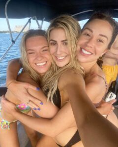 Emma Slater and Gabby Windey on boat in bikinis