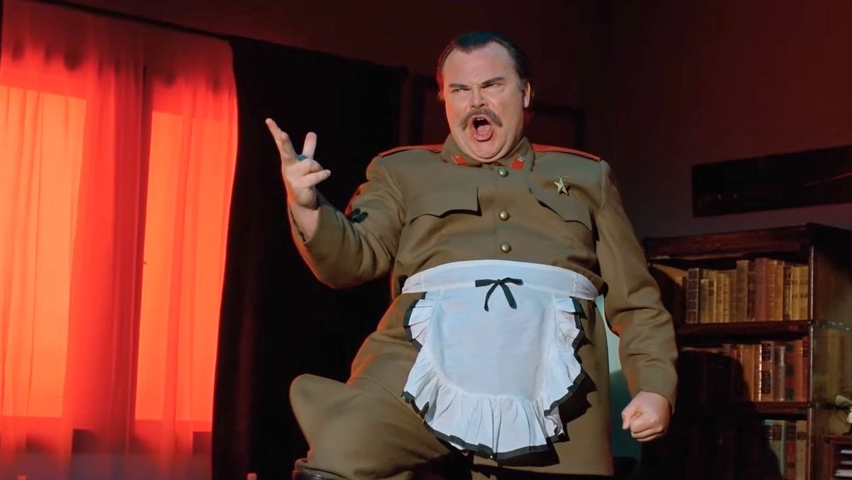 Jack Black stands on a table singing as Josef Stalin on History of the World Part 2