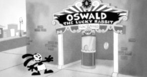 a black and white rabbit stands in front of a movie theater that says “Oswald the Lucky Rabbit” on the marquee