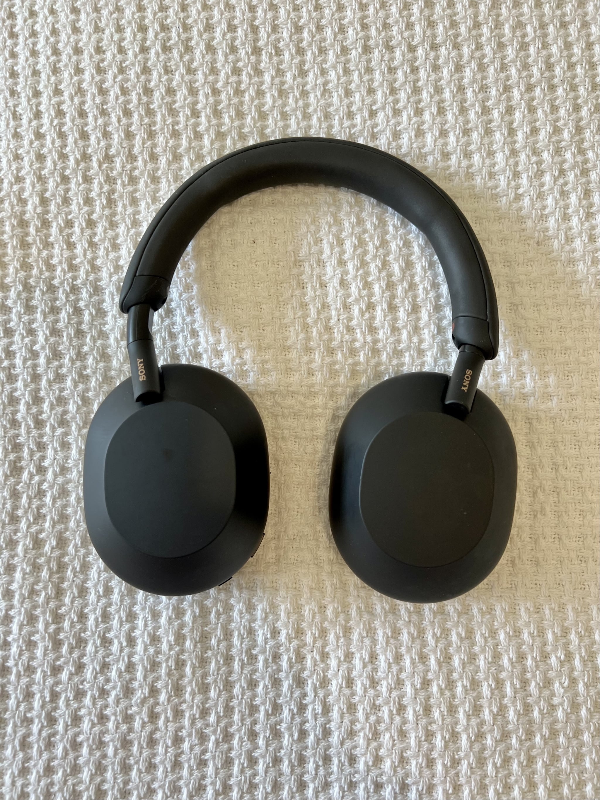 The Sony WH-1000XM5 Noise Canceling Headphones on white surface.