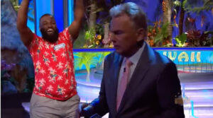 Henry bursted with energy behind Wheel of Fortune host Pat Sajak