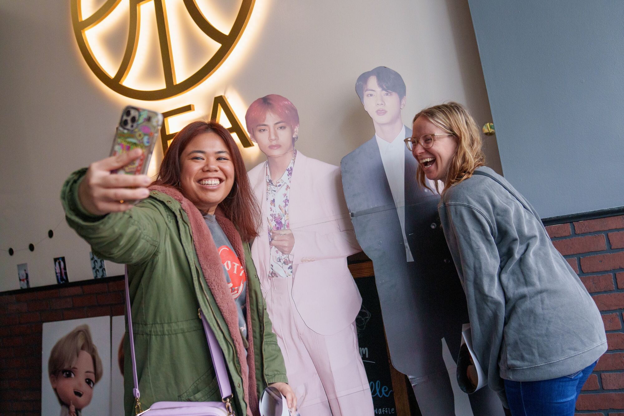 Caitlin Baul, and Traci Doramal take a selfie with cut outs during a cupsleeve event at R&B Tea.