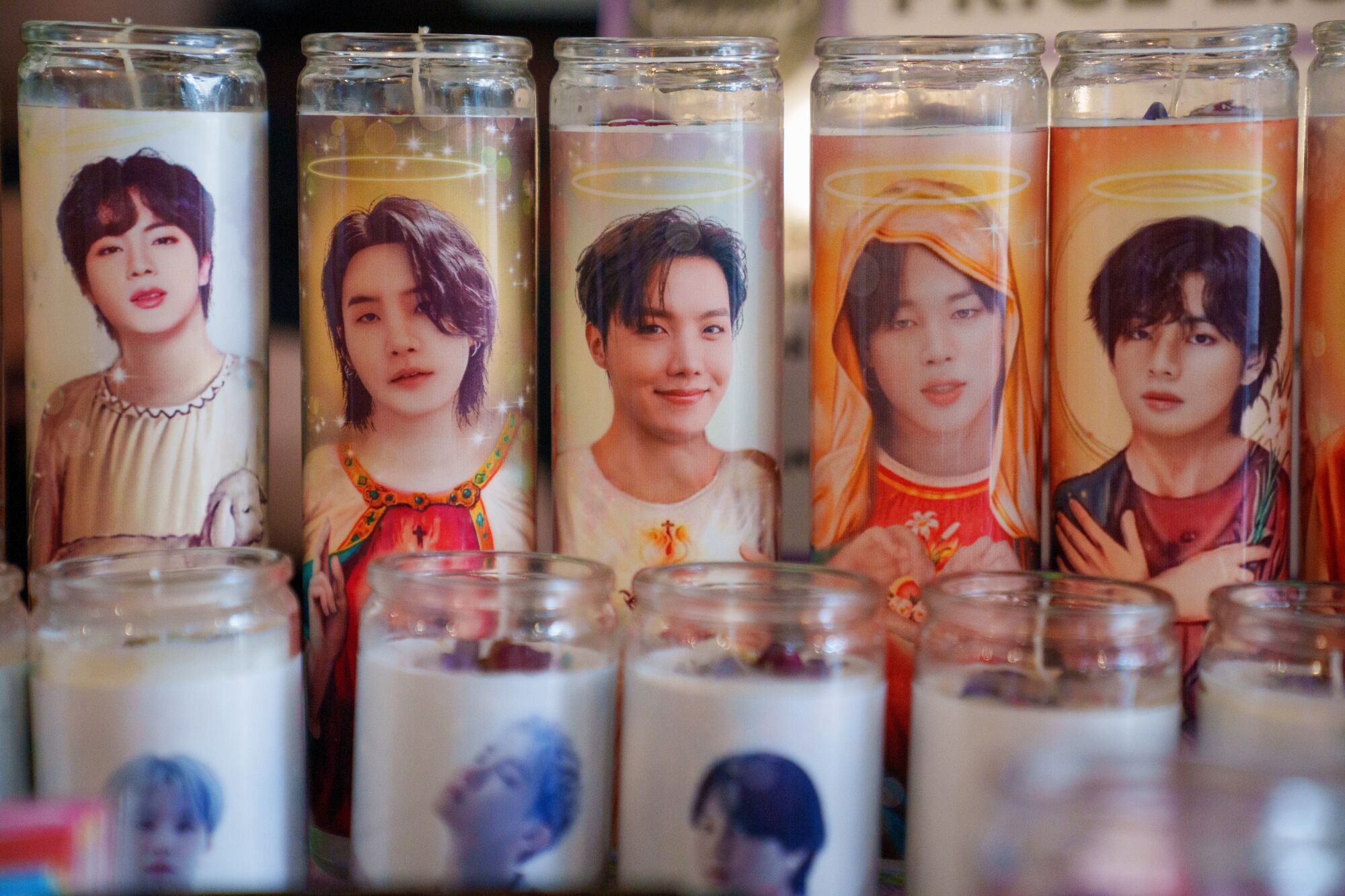 Votive candles featuring various K-pop stars.