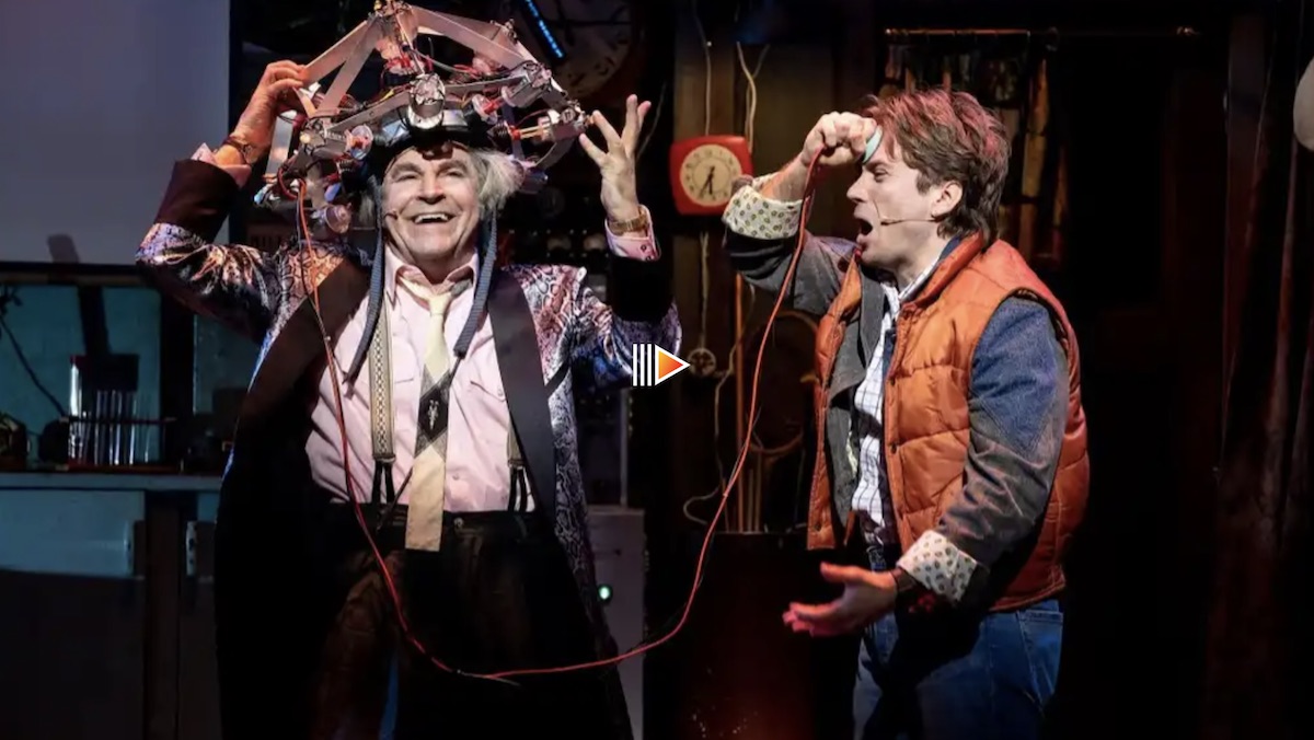 Doc Brown with his giant head contraption with a cord stuck to Mary's head in Back to the Future: The Musical