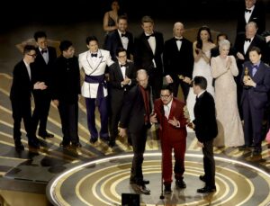 Daniel Scheinert, Daniel Kwan, and Jonathan Wang accept the Best Picture award for “Everything Everywhere All at Once” along with cast and crew onstage during the 95th Annual Academy Awards