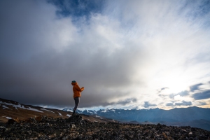 Kris Tompkins looks up at the sky with the Patagonian mountain range as her backdrop.