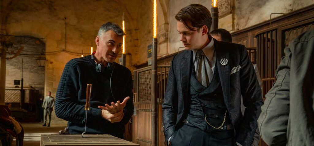 Director Chad Stahelski talks to actor Bill Skarsgård in a stable for a scene in John Wick: Chapter 4
