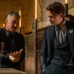 Director Chad Stahelski talks to actor Bill Skarsgård in a stable for a scene in John Wick: Chapter 4
