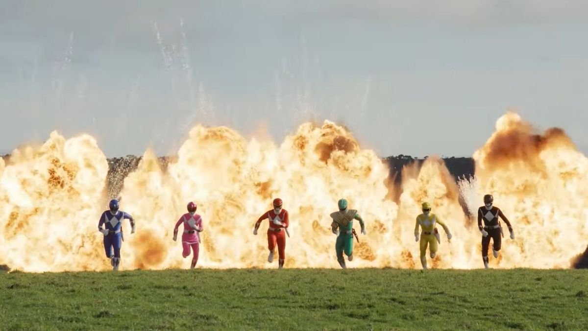 a lineup of power rangers run from an explosion in a field in reunion trailer 