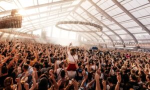 concert crowd in a glass-roofed space