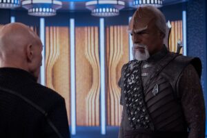 An older Worf (Michael Dorn) standing and talking to Picard (Patrick Stewart)