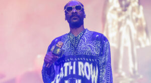 Watch Snoop Dogg Touch Down in Scotland as Bagpiper Plays “Still D.R.E.”