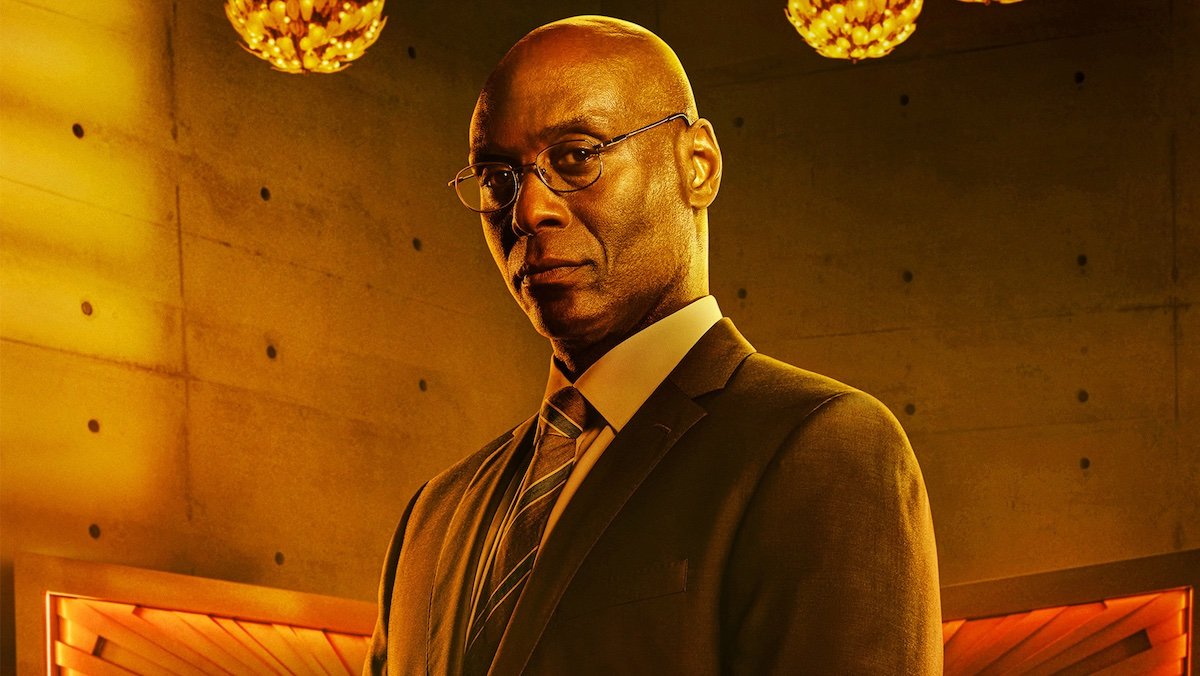 Character poster for Lance Reddick's Charon in a suit and glasses from John Wick: Chapter 4