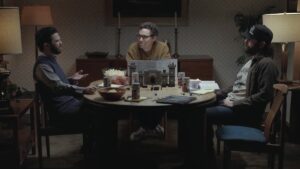 Three men sitting at a table playing Dungeons and Dragons