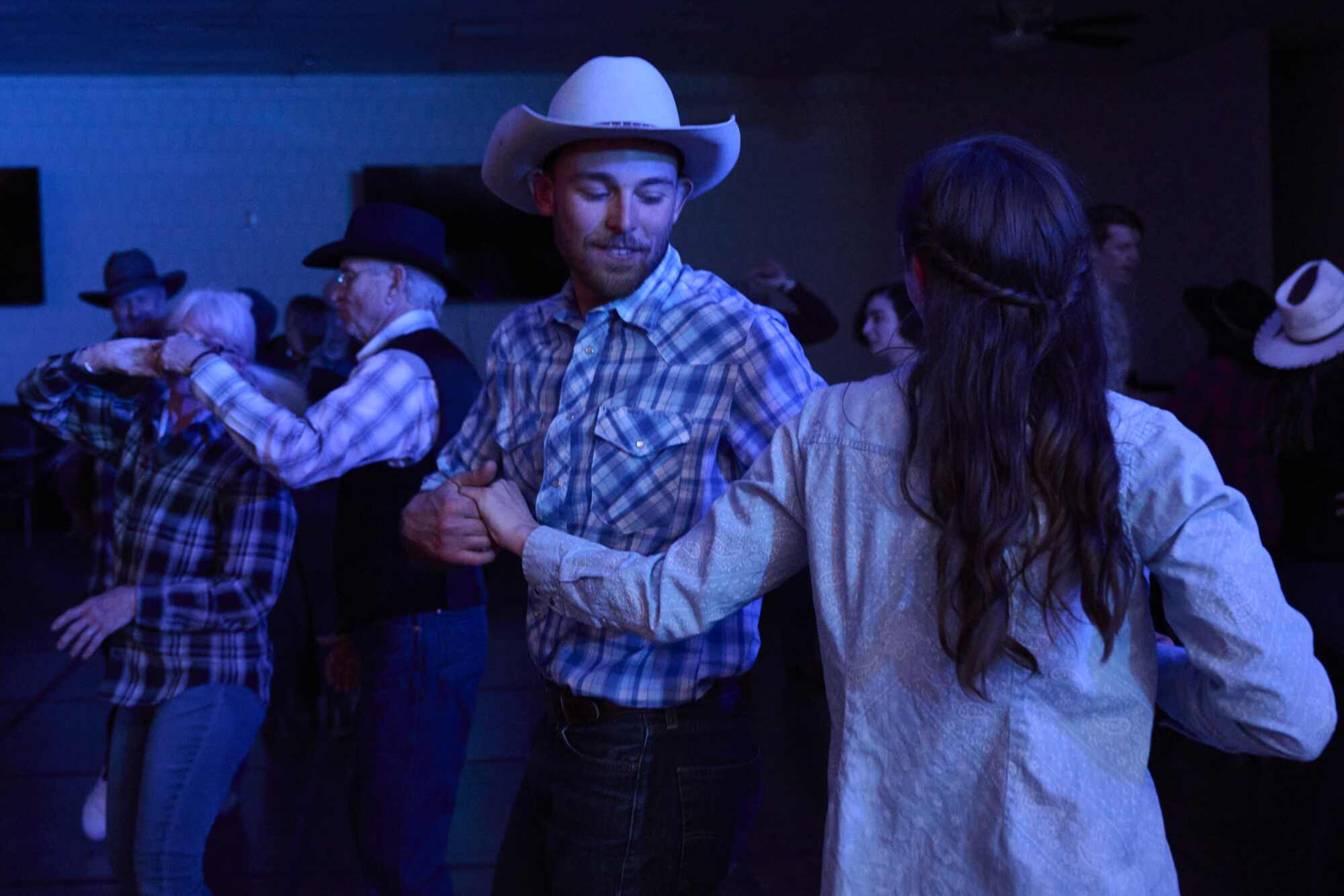 Luke Schranz, left, and Alex Monroe dance together at  the National Cowboy Poetry Gathering.