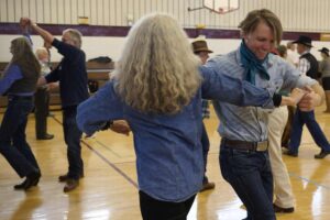 Kirsten Gleissner, left, and Andrew Church dance together during a rodeo swing workshop.